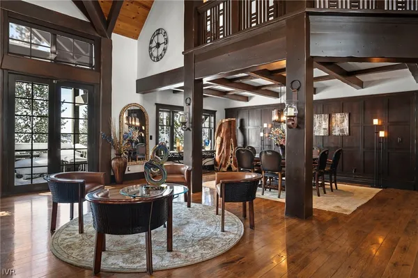a dining room with furniture a rug and chandelier