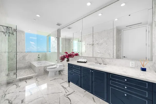 a bathroom with a double vanity sink mirror and toilet