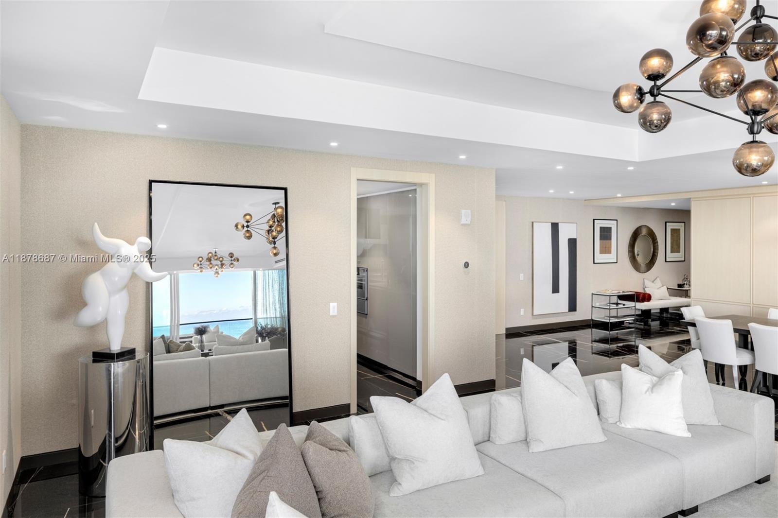 9349 Collins Avenue, Unit 406 Surfside, FL 33154 - Photo 14 of 48 a living room with furniture and a flat screen tv