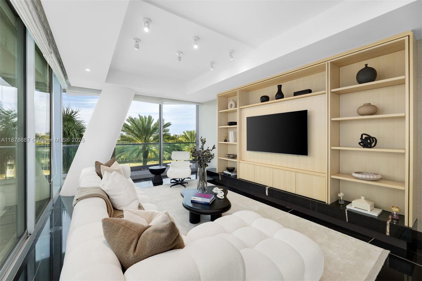 9349 Collins Avenue, Unit 406 Surfside, FL 33154 - Photo 18 of 48 a living room with furniture potted plant and a flat screen tv