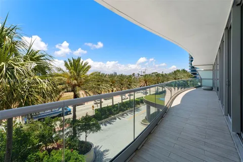 a view of a balcony with wooden floor and lake view