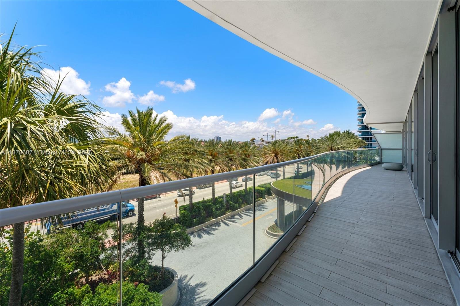 9349 Collins Avenue, Unit 406 Surfside, FL 33154 - Photo 27 of 48 a view of a balcony with wooden floor and lake view