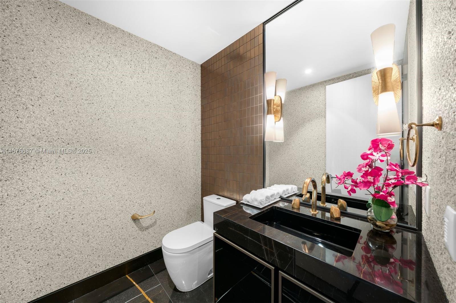 9349 Collins Avenue, Unit 406 Surfside, FL 33154 - Photo 31 of 48 a bathroom with a sink mirror vanity and toilet