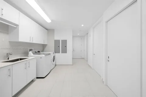 a large white kitchen with white cabinets