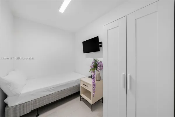 a bathroom with a bathtub and a flat screen tv