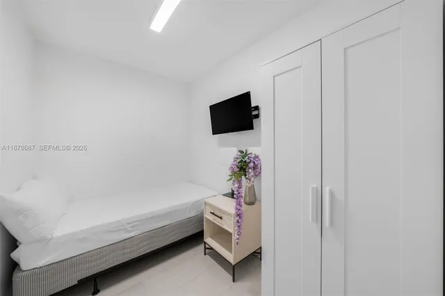 a bathroom with a bathtub and a flat screen tv