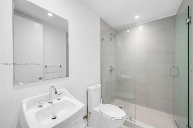 a bathroom with a sink toilet and shower