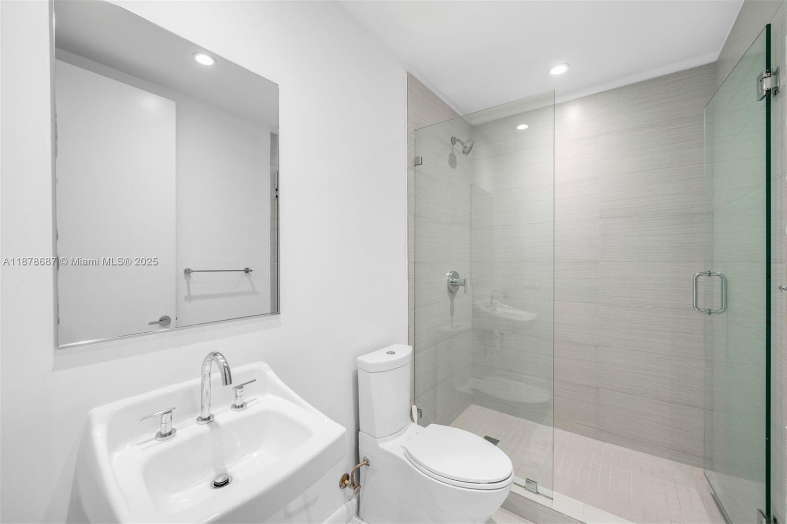 9349 Collins Avenue, Unit 406 Surfside, FL 33154 - Photo 35 of 48 a bathroom with a sink toilet and shower