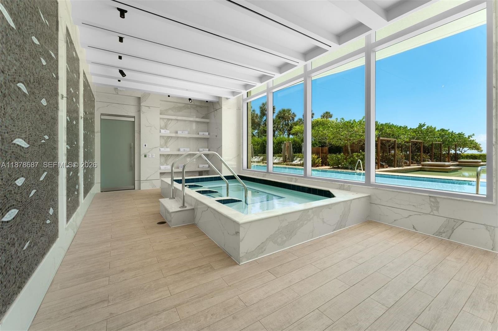 9349 Collins Avenue, Unit 406 Surfside, FL 33154 - Photo 41 of 48 a swimming pool with outdoor seating and yard