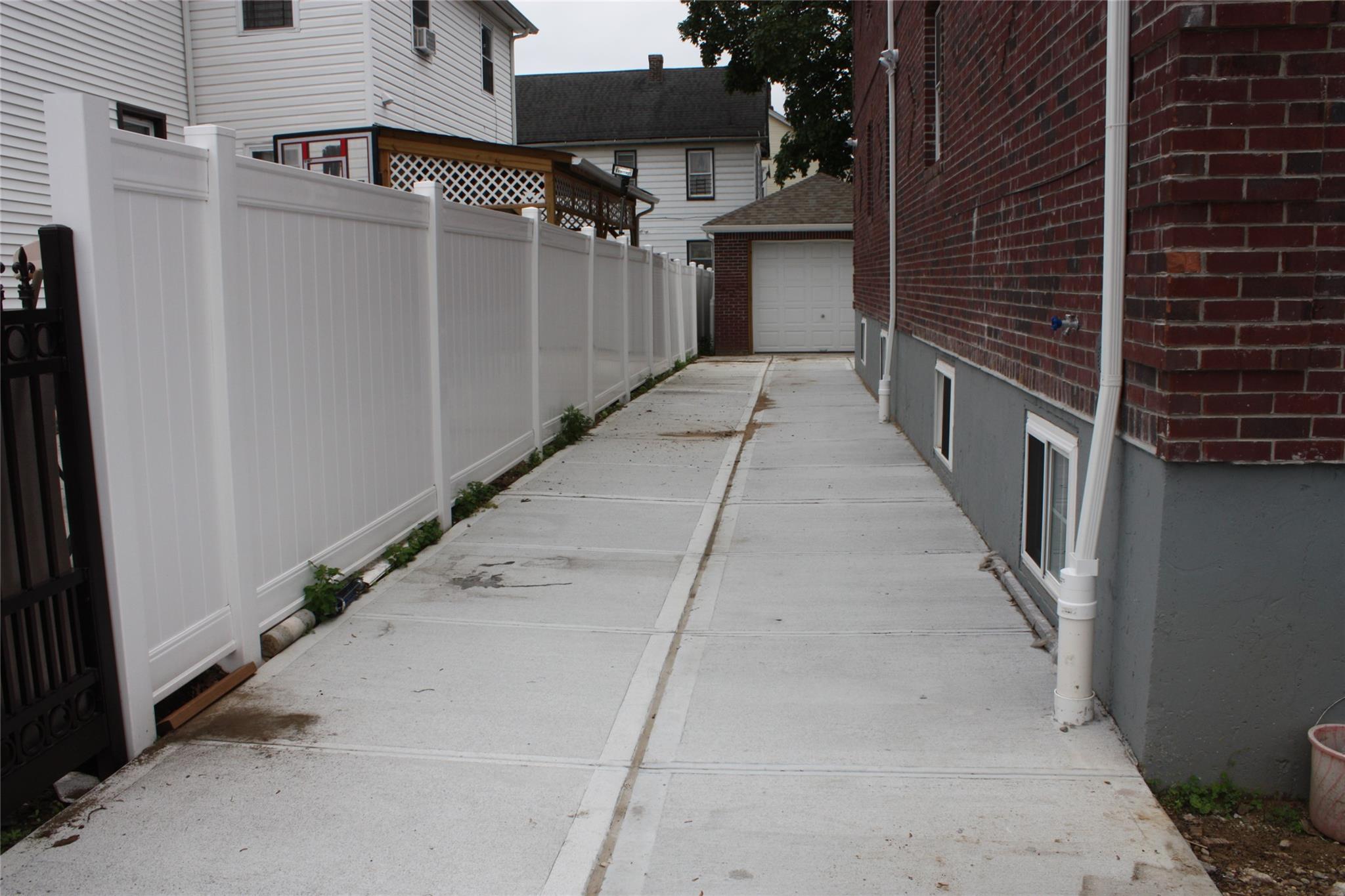 157-18 115th Road, Unit 2 FAMILY Queens, NY 11434 - Photo 14 of 36 a view of a pathway of a building