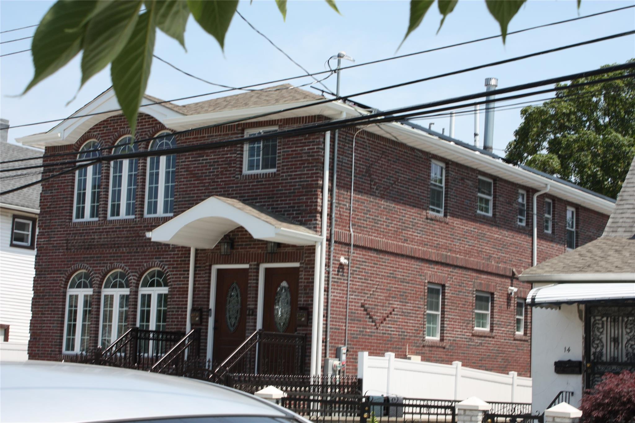 157-18 115th Road, Unit 2 FAMILY Queens, NY 11434 - Photo 16 of 36 a front view of a house