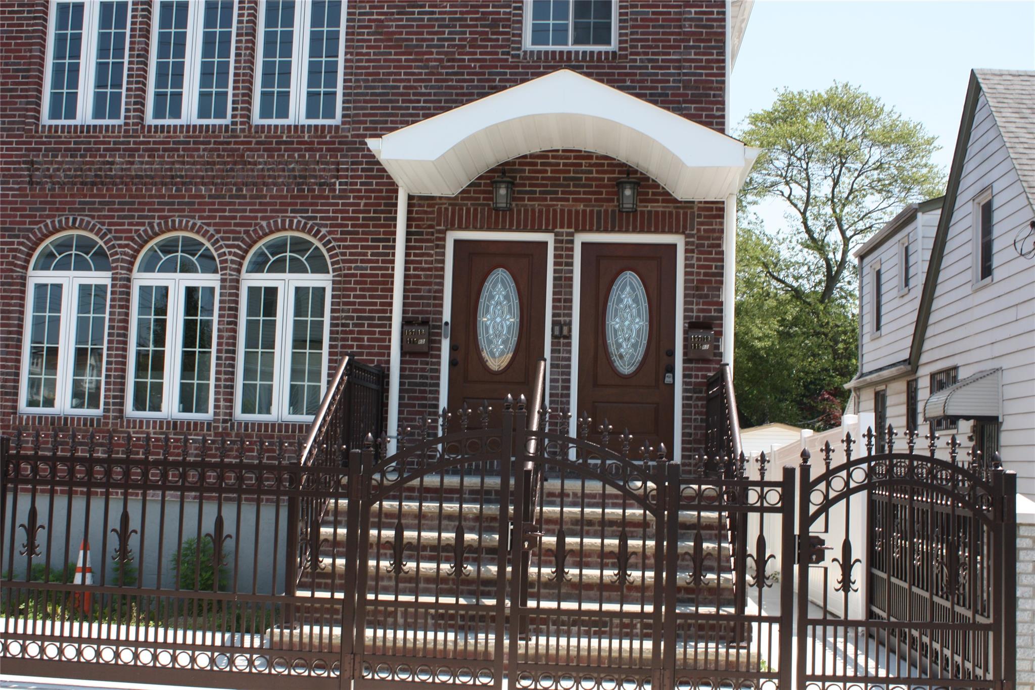 157-18 115th Road, Unit 2 FAMILY Queens, NY 11434 - Photo 17 of 36 a front view of a house with garden