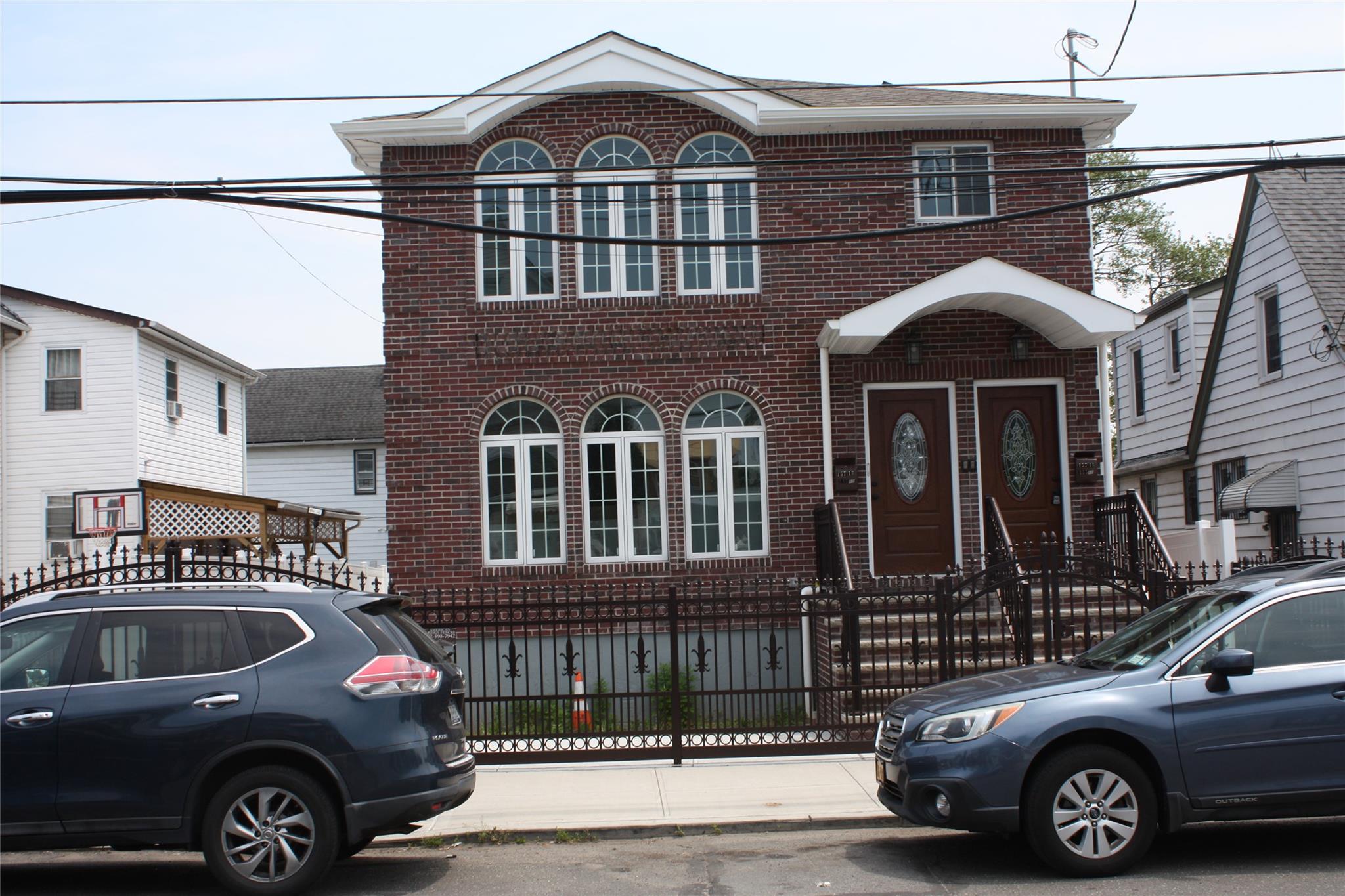 157-18 115th Road, Unit 2 FAMILY Queens, NY 11434 - Photo 20 of 36 a front view of a house with a parking space