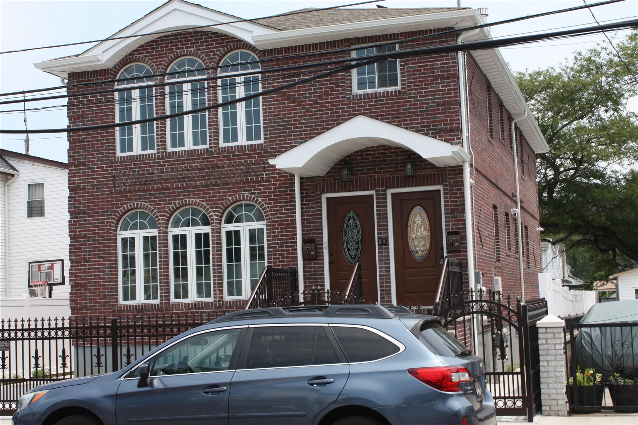 157-18 115th Road, Unit 2 FAMILY Queens, NY 11434 - Photo 21 of 36 a front view of a house with a yard