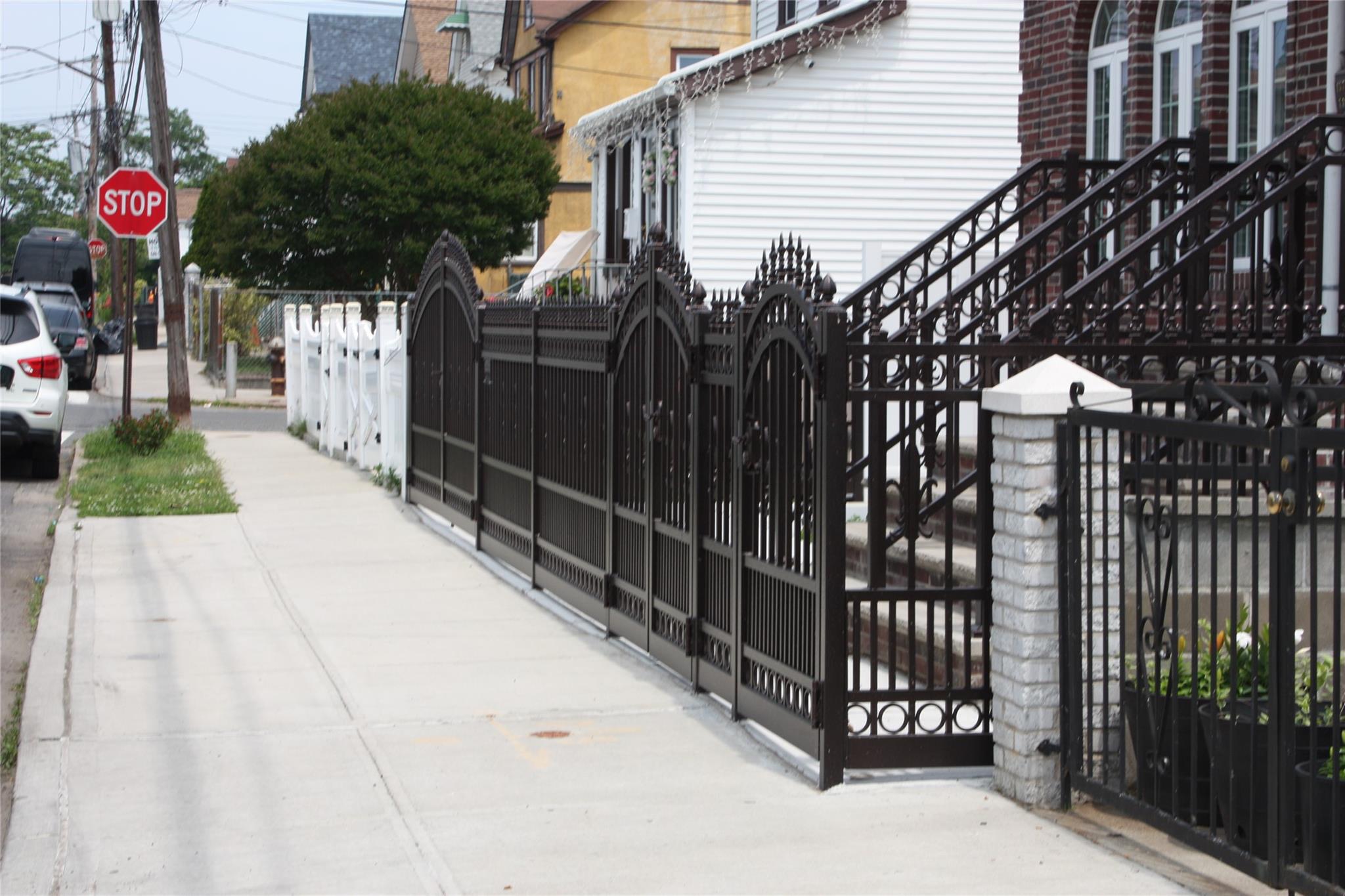 157-18 115th Road, Unit 2 FAMILY Queens, NY 11434 - Photo 22 of 36 a view of a house with a small yard and wooden fence