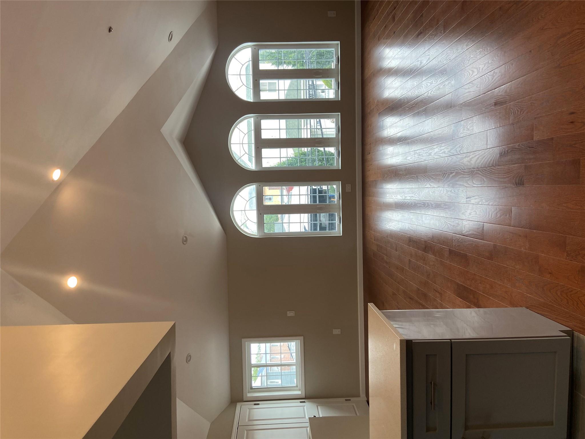 157-18 115th Road, Unit 2 FAMILY Queens, NY 11434 - Photo 27 of 36 a view of a livingroom with wooden floor and staircase