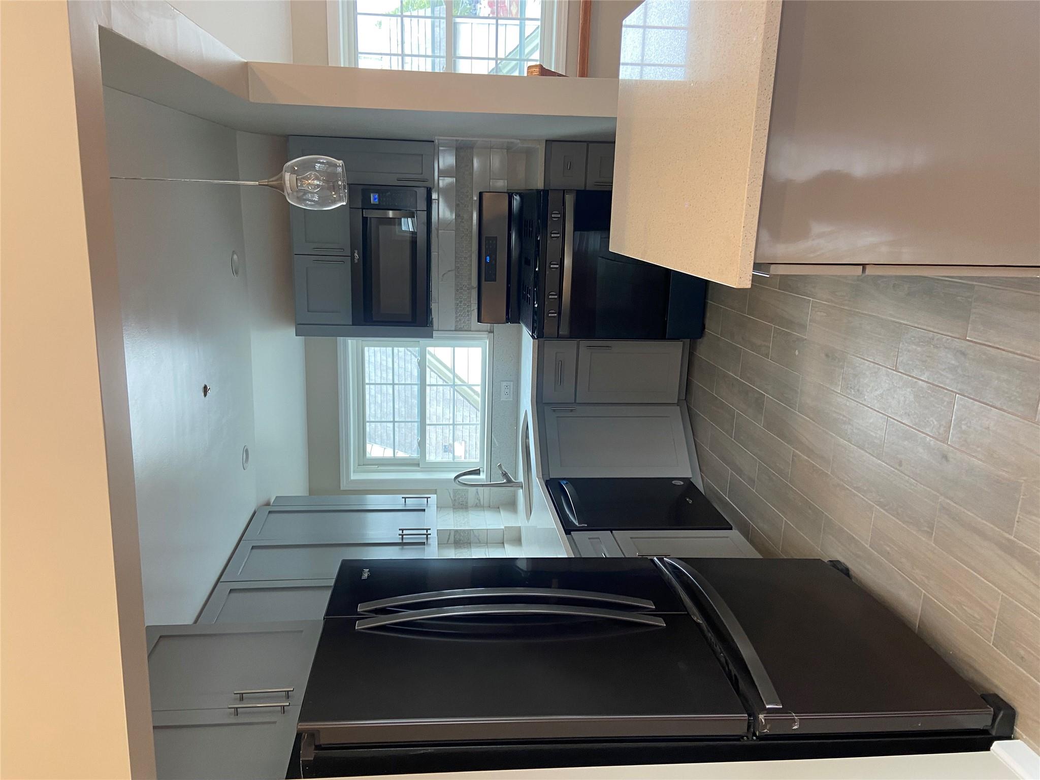 157-18 115th Road, Unit 2 FAMILY Queens, NY 11434 - Photo 29 of 36 a kitchen with stainless steel appliances a refrigerator and a stove