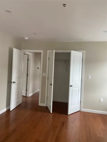 a kitchen with granite countertop white cabinets and wooden floor