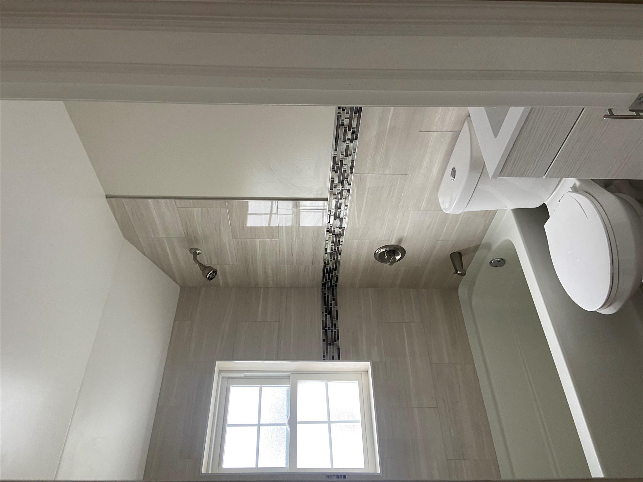 157-18 115th Road, Unit 2 FAMILY Queens, NY 11434 - Photo 34 of 36 a bathroom with a sink a toilet and a bathtub