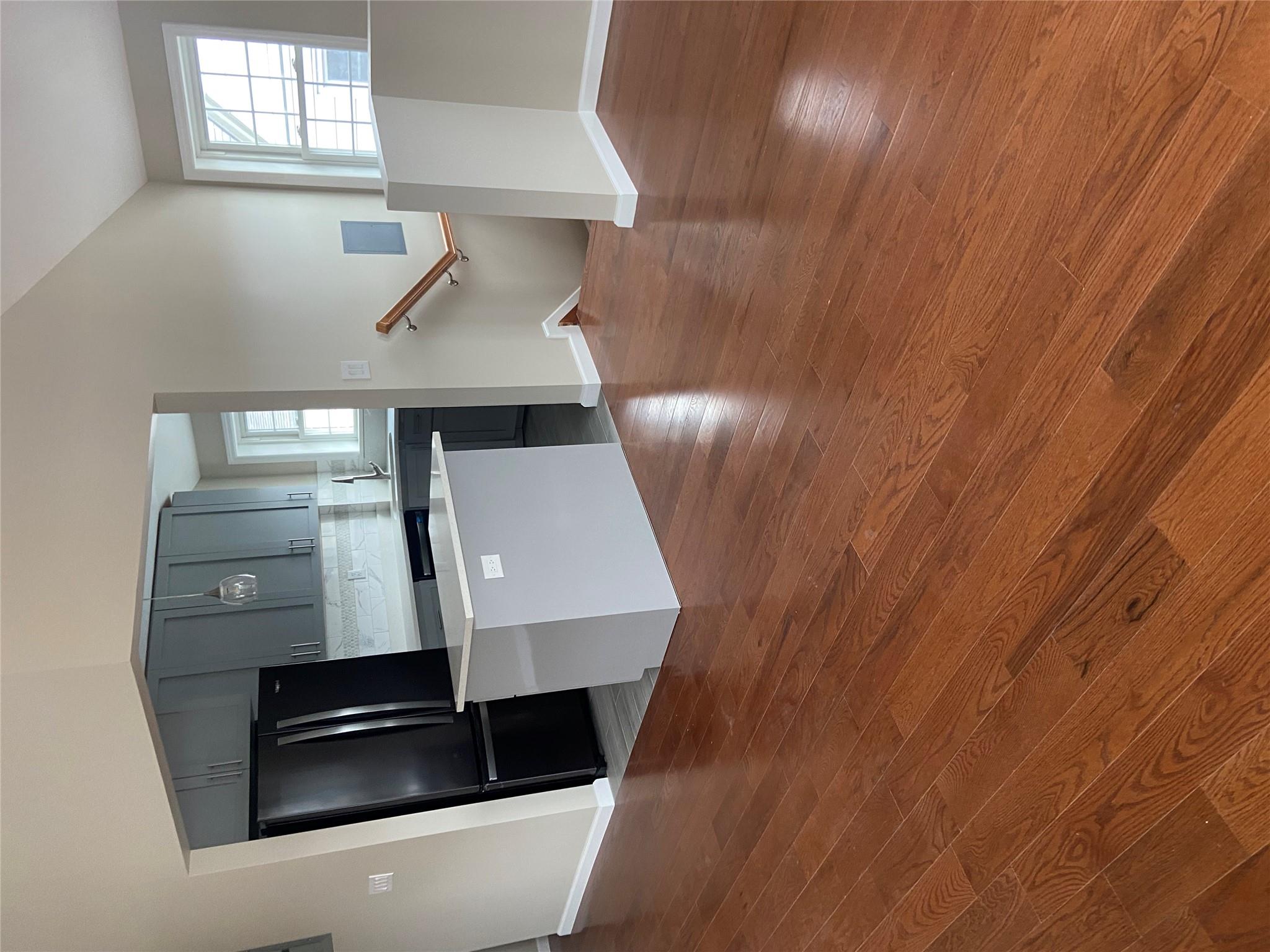 157-18 115th Road, Unit 2 FAMILY Queens, NY 11434 - Photo 36 of 36 a kitchen with granite countertop white cabinets and wooden floor