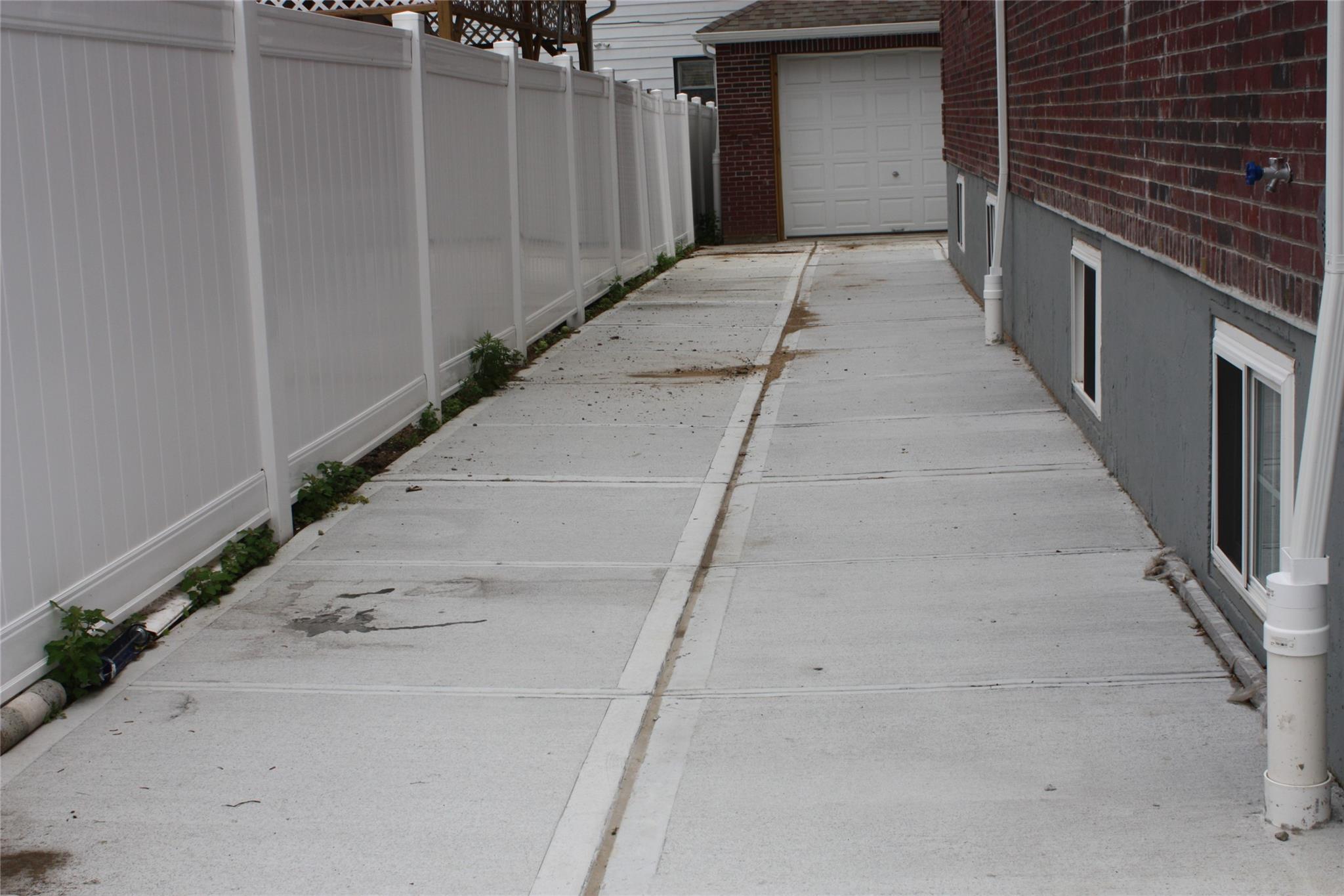 157-18 115th Road, Unit 2 FAMILY Queens, NY 11434 - Photo 8 of 36 a view of a pathway besides a building