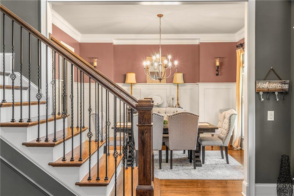 5605 Copper Creek Pass Cumming, GA 30040 - Photo 13 of 64 a view of a dining room with furniture and chandelier