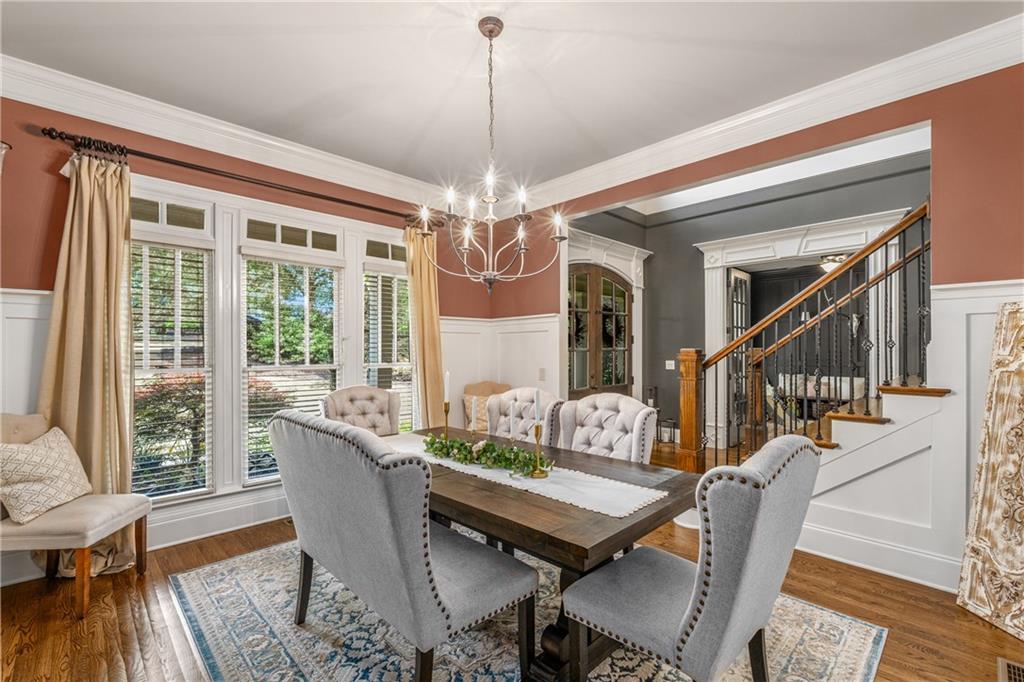 5605 Copper Creek Pass Cumming, GA 30040 - Photo 14 of 64 a view of a dining room with furniture wooden floor and chandelier