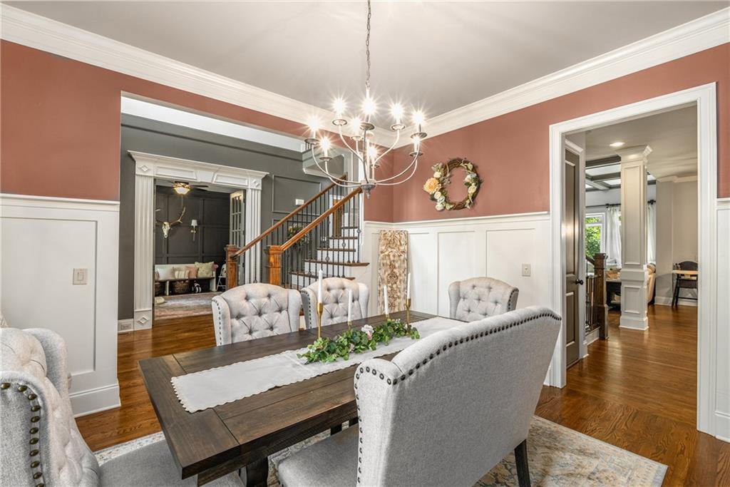 5605 Copper Creek Pass Cumming, GA 30040 - Photo 15 of 64 a living room with furniture a chandelier and a dining table