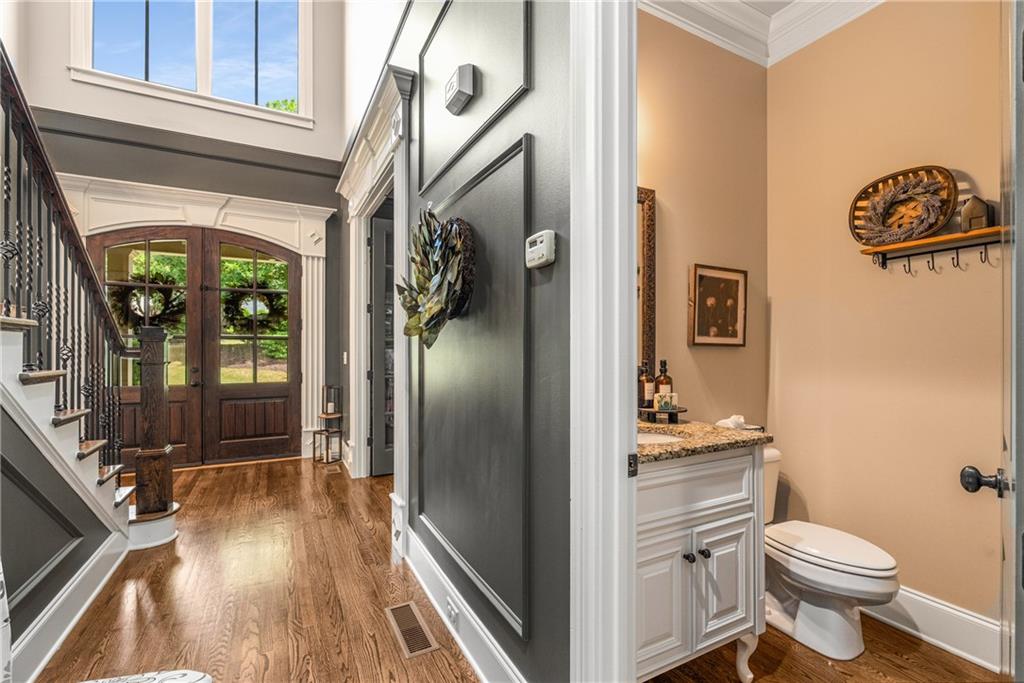 5605 Copper Creek Pass Cumming, GA 30040 - Photo 16 of 64 a bathroom with a toilet a sink and shower