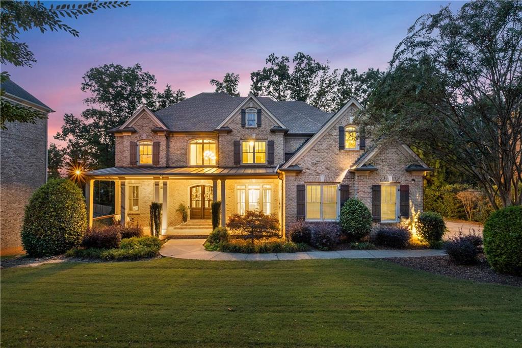 5605 Copper Creek Pass Cumming, GA 30040 - Photo 2 of 64 a front view of a house with garden