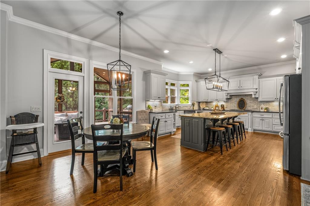 5605 Copper Creek Pass Cumming, GA 30040 - Photo 22 of 64 a view of a dining room and livingroom with furniture wooden floor kitchen chandelier