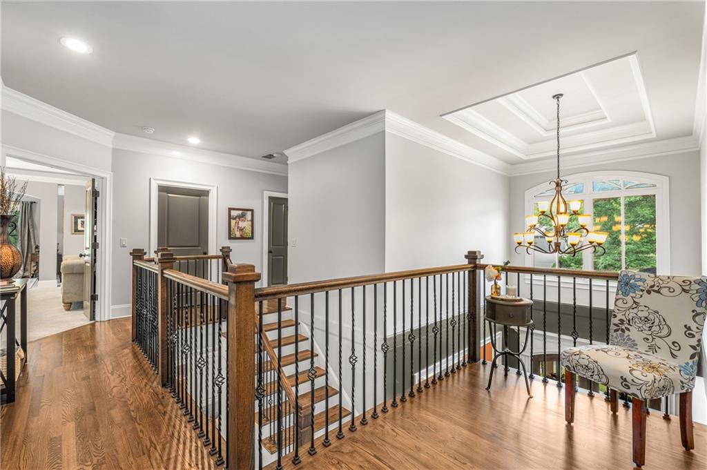 5605 Copper Creek Pass Cumming, GA 30040 - Photo 31 of 64 a view of a hallway with wooden floor and windows