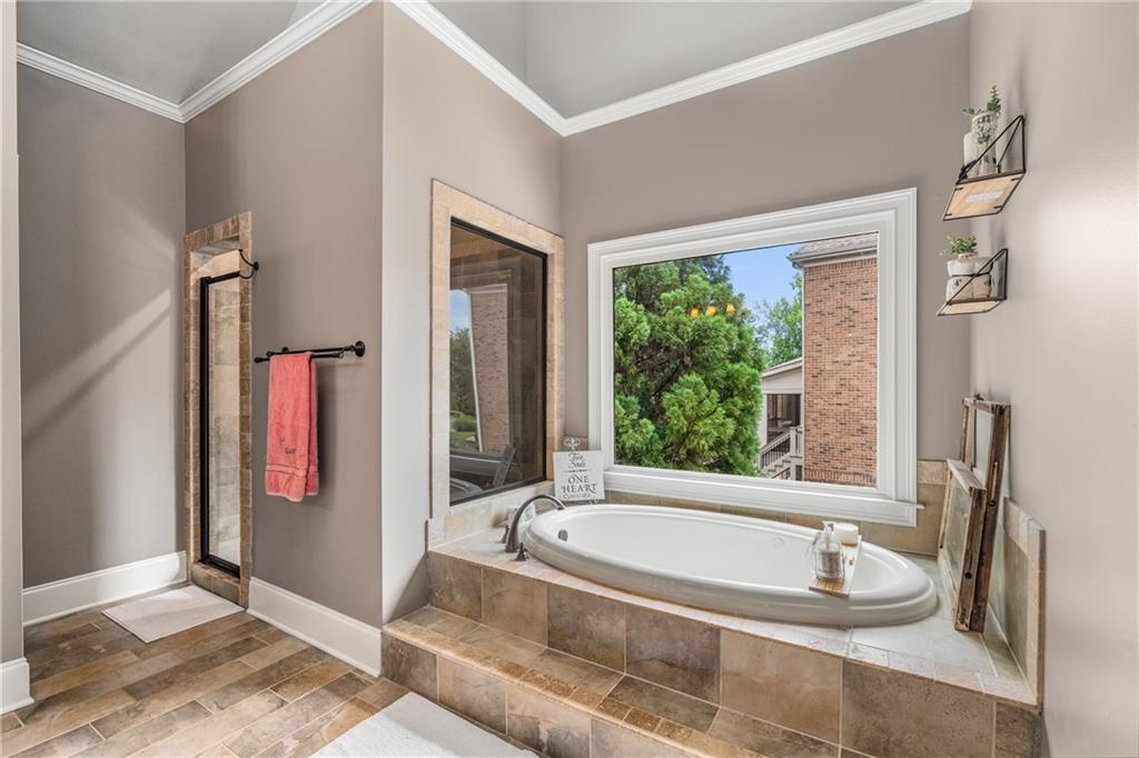 5605 Copper Creek Pass Cumming, GA 30040 - Photo 34 of 64 a bathroom with a tub and a sink