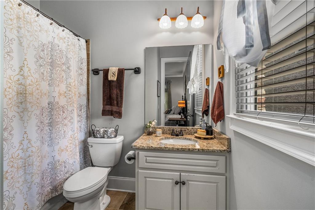 5605 Copper Creek Pass Cumming, GA 30040 - Photo 36 of 64 a bathroom with a sink vanity mirror and toilet