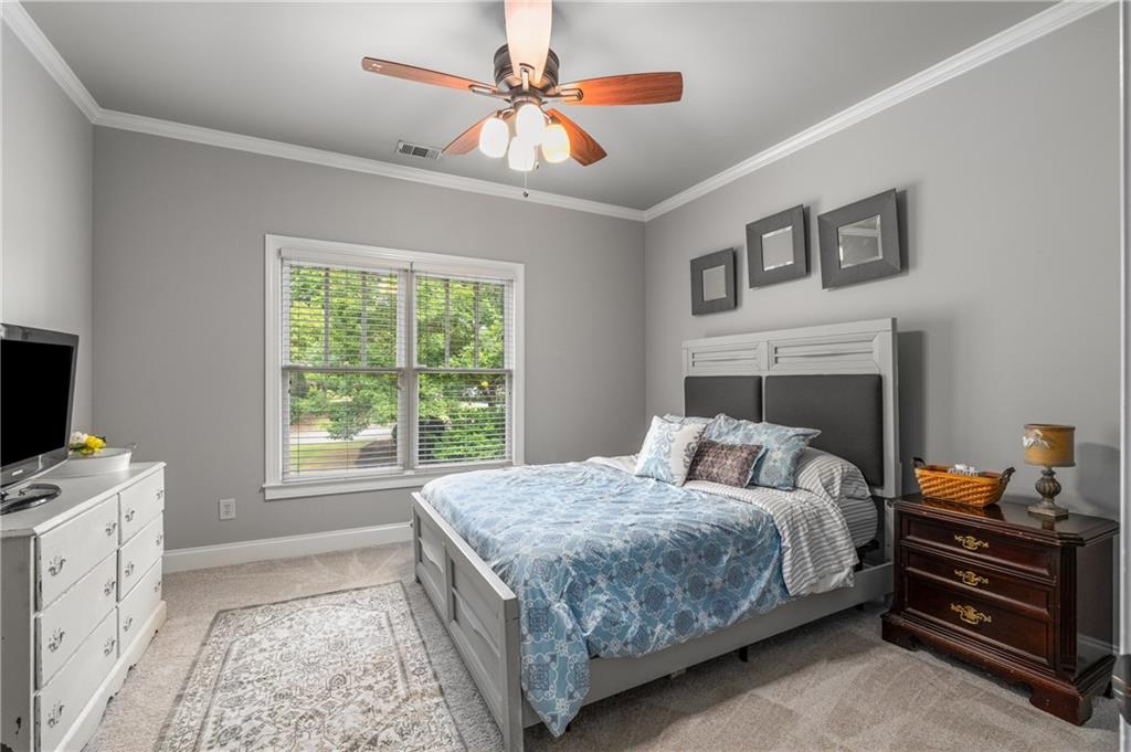 5605 Copper Creek Pass Cumming, GA 30040 - Photo 37 of 64 a bedroom with a bed and a tv on the dresser