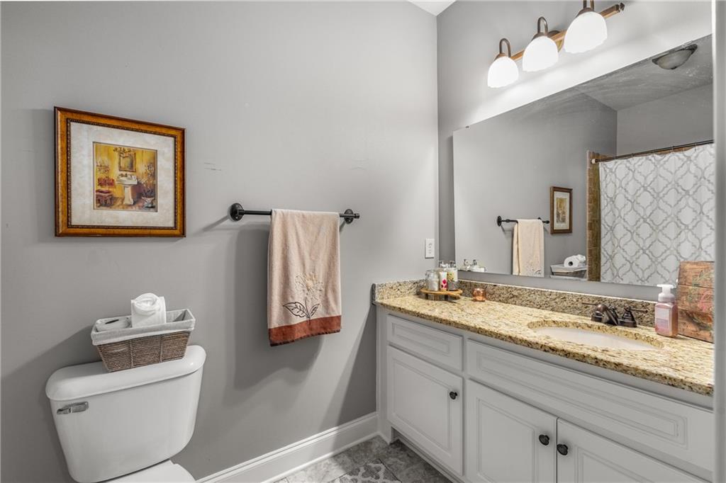 5605 Copper Creek Pass Cumming, GA 30040 - Photo 38 of 64 a bathroom with a granite countertop sink mirror and toilet