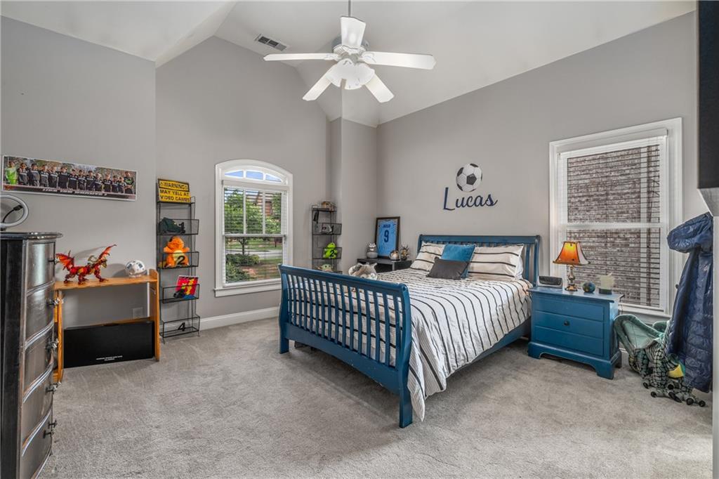 5605 Copper Creek Pass Cumming, GA 30040 - Photo 39 of 64 a bedroom with bed and a chandelier