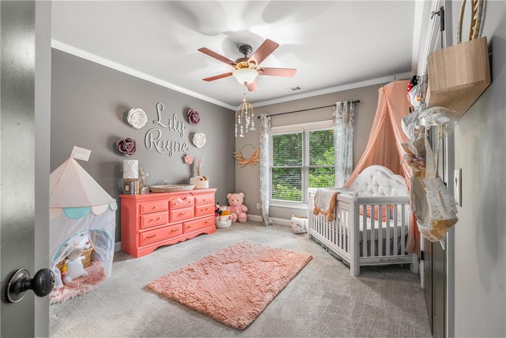 5605 Copper Creek Pass Cumming, GA 30040 - Photo 41 of 64 a bedroom with a bed and a window