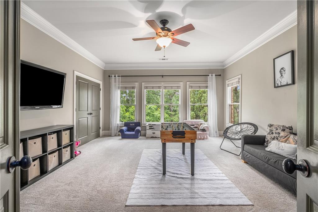 5605 Copper Creek Pass Cumming, GA 30040 - Photo 43 of 64 a living room with furniture tv and a window