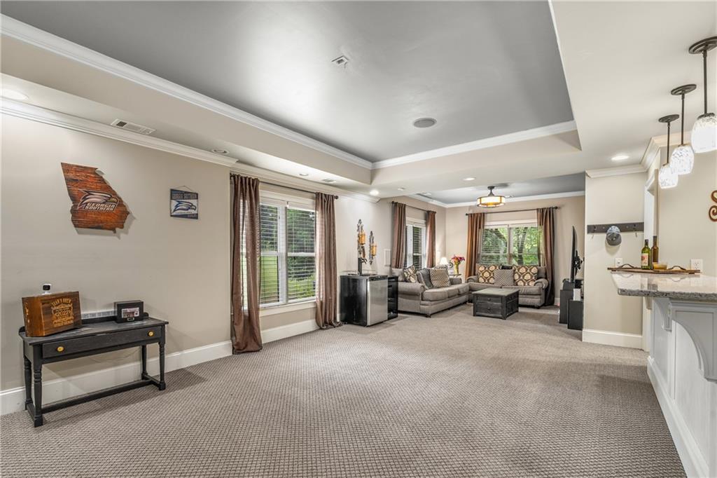 5605 Copper Creek Pass Cumming, GA 30040 - Photo 47 of 64 a living room with furniture gym equipment and a large window