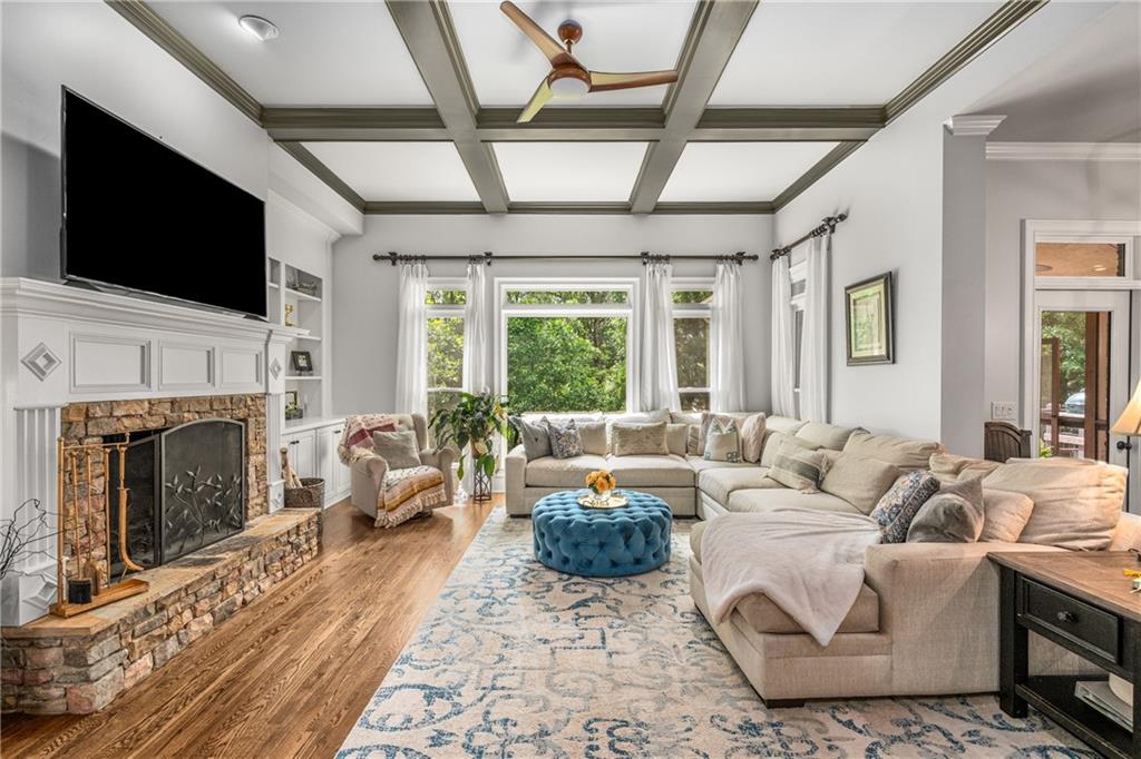5605 Copper Creek Pass Cumming, GA 30040 - Photo 5 of 64 a living room with furniture a fireplace and a flat screen tv