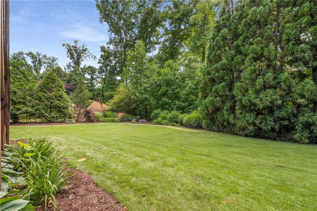 5605 Copper Creek Pass Cumming, GA 30040 - Photo 52 of 64 a view of a field with an trees