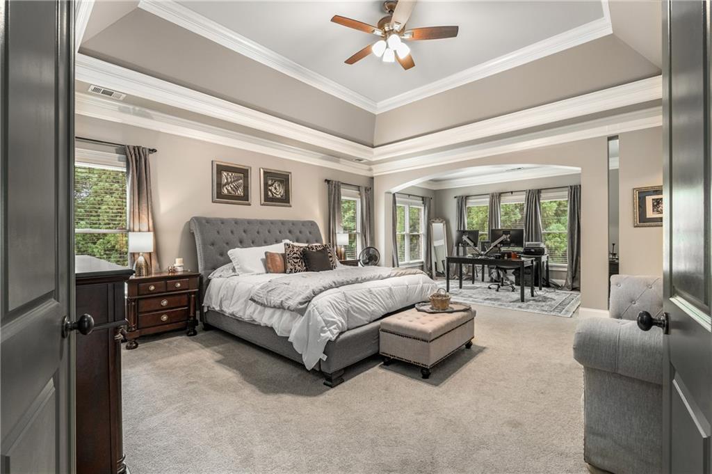 5605 Copper Creek Pass Cumming, GA 30040 - Photo 6 of 64 a spacious bedroom with a bed and glass walk in closet
