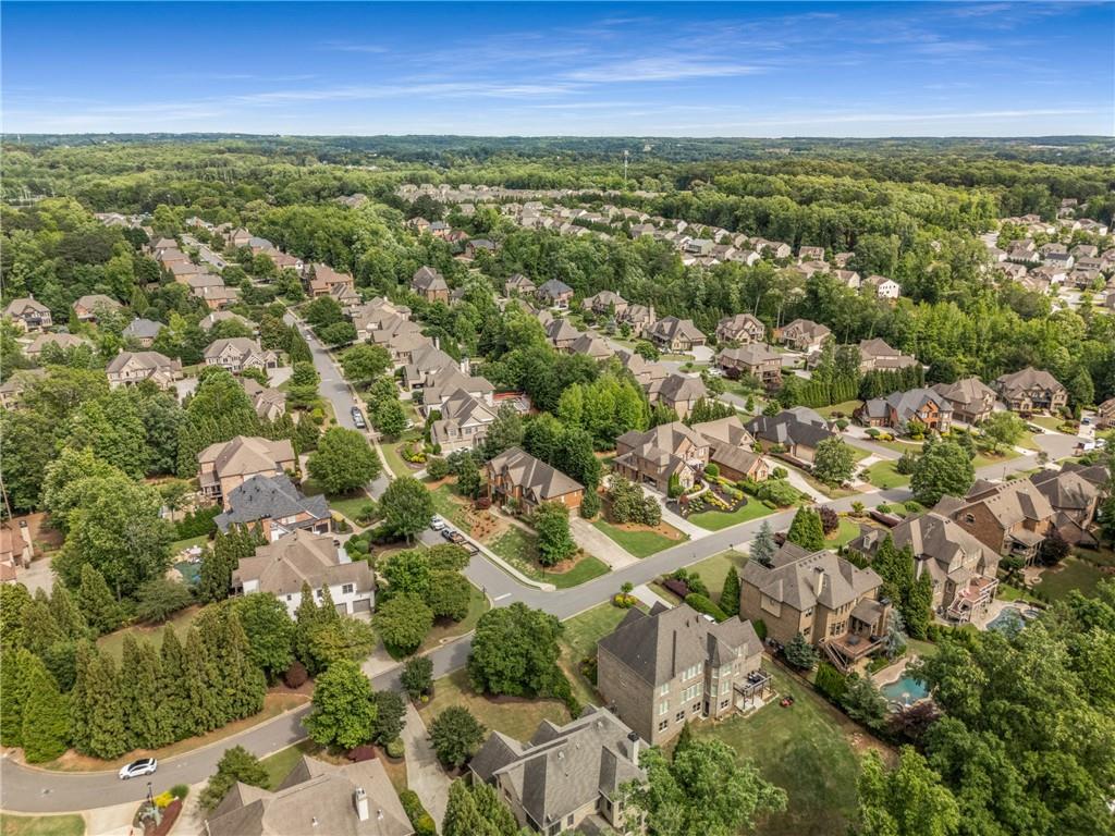 5605 Copper Creek Pass Cumming, GA 30040 - Photo 64 of 64 an aerial view of residential houses with outdoor space and trees