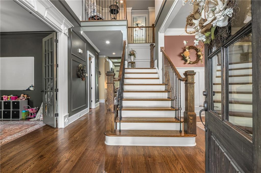 5605 Copper Creek Pass Cumming, GA 30040 - Photo 10 of 64 a view of entryway and hall with wooden floor