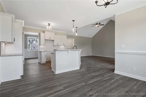 a kitchen with stainless steel appliances a refrigerator and a stove top oven