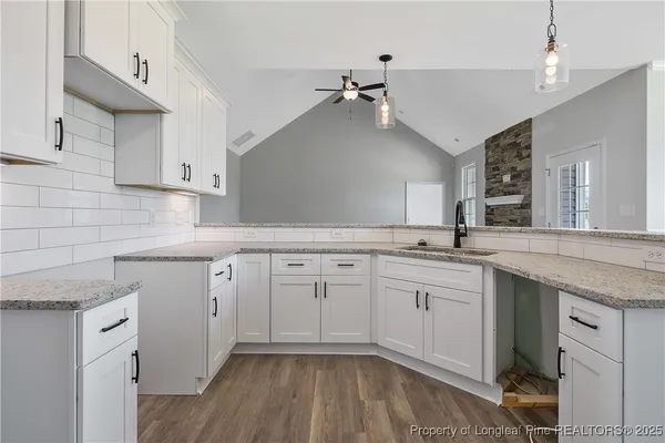a kitchen with cabinets appliances and a sink