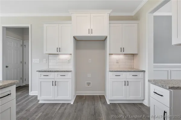 a kitchen with white cabinets and a sink