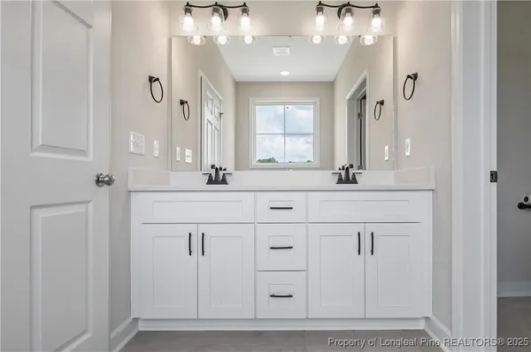 a bathroom with a sink vanity and a mirror
