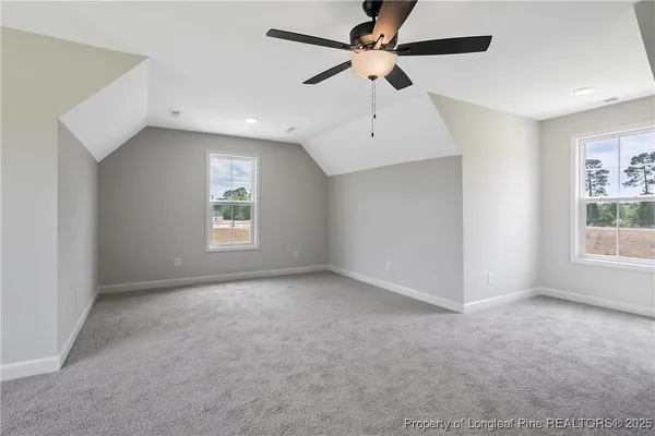 an empty room with closet and a ceiling fan